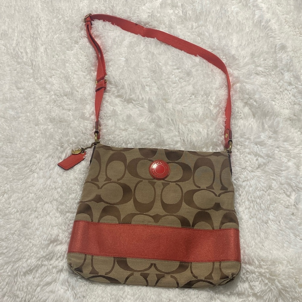 Coach crossover purse over shoulder coral tan orange